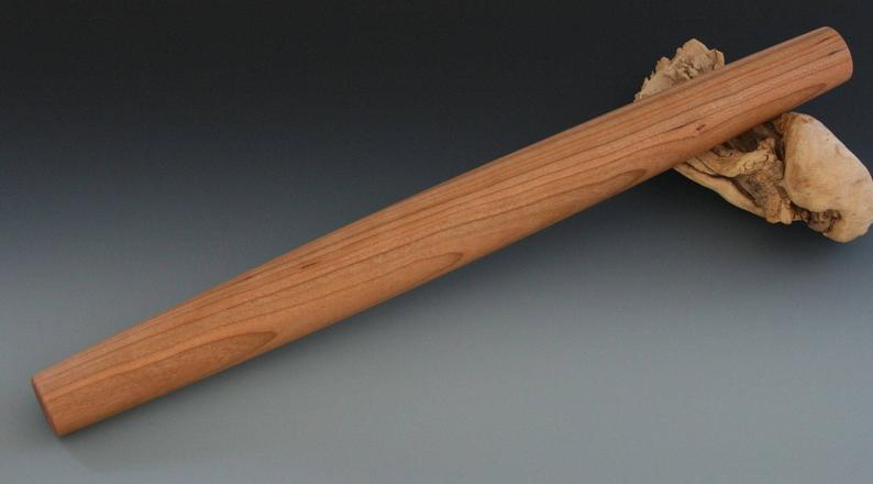 Cherry wood French rolling pin with tapered ends.