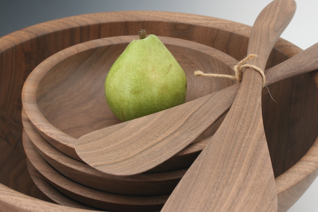 Woodturned walnut wood salad bowl service set.