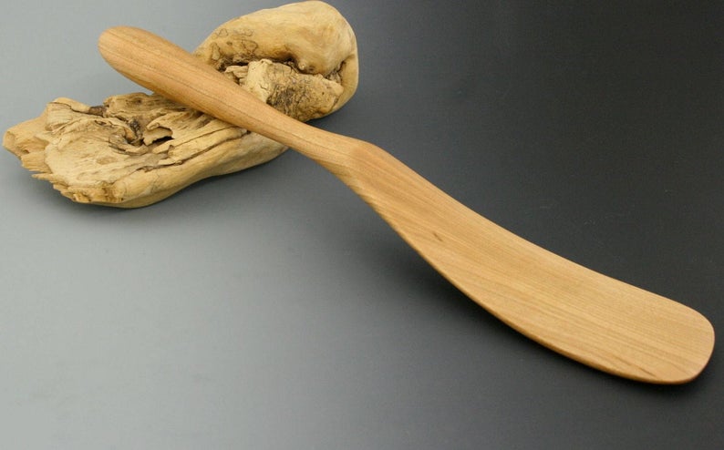 Handmade unique cherry wood spatula with slightly scooped shape.