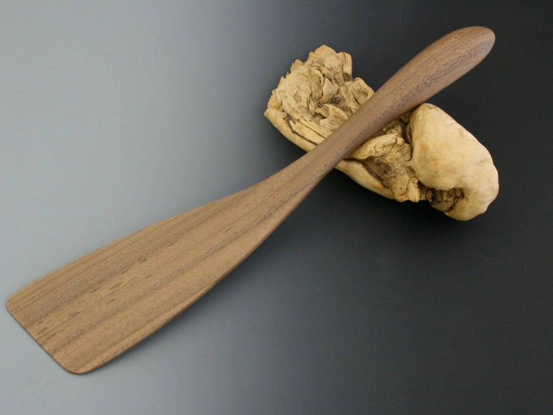 Walnut wood French spatula with thin blade.