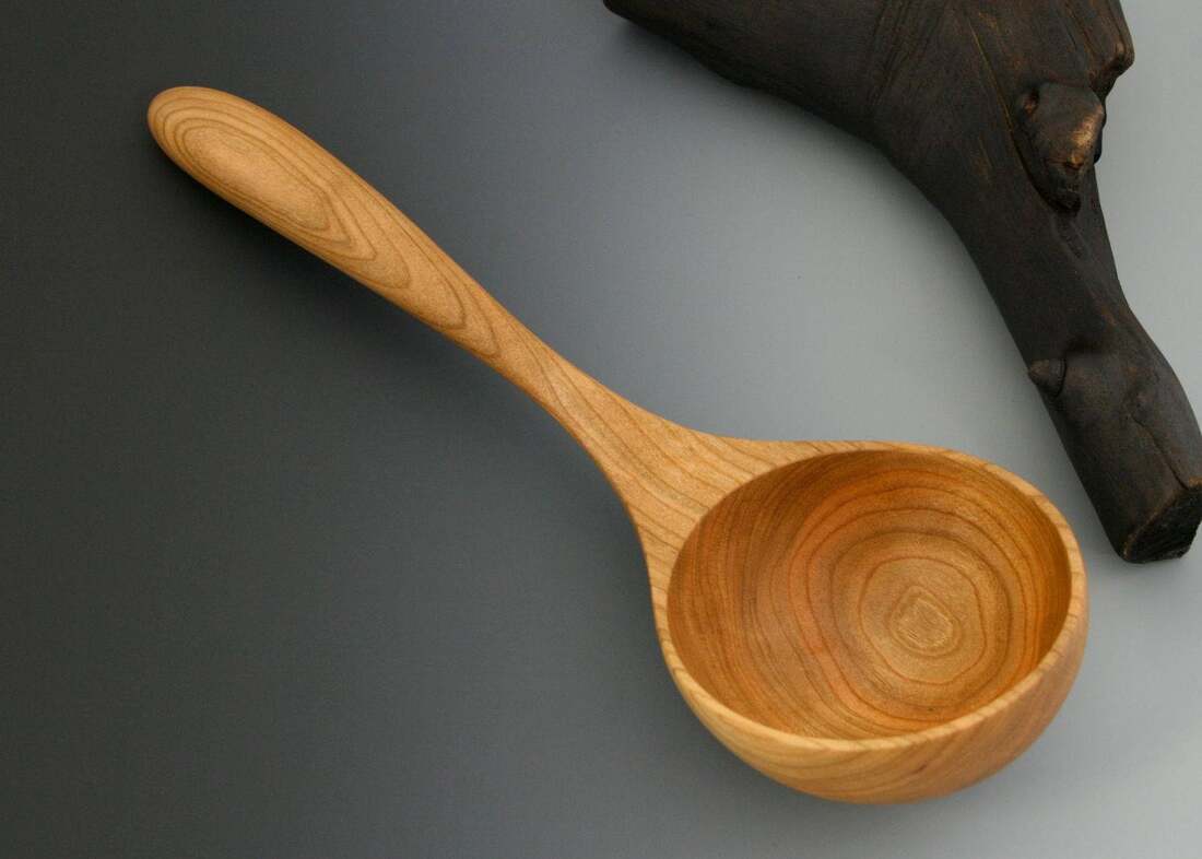 Handmade cherry wood serving ladle spoon with large, deep bowl.