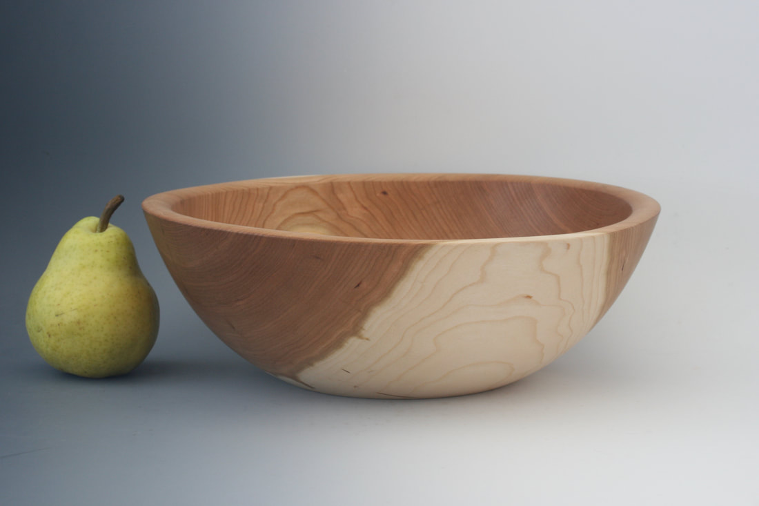 Cherry wood turned bowl with fruit.