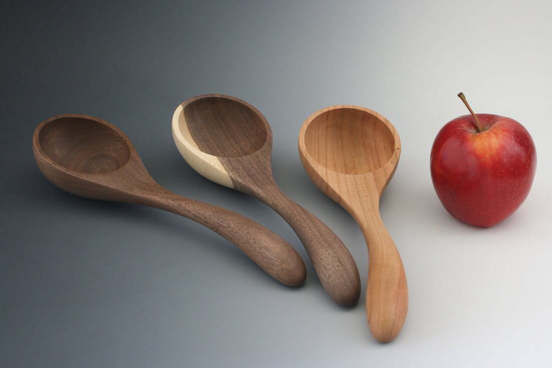 Small table ladle with curved handle in walnut and cherry wood options.