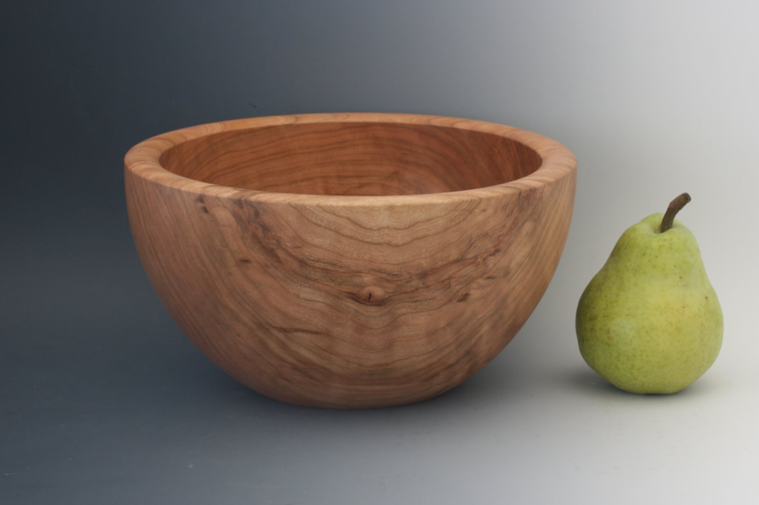 Black cherry vessel shaped wood bowl.