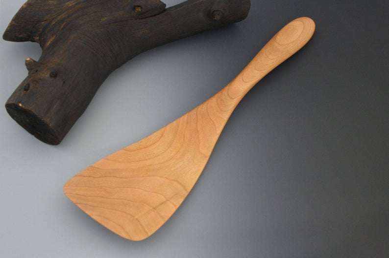 Small cherry wood spatula with a wide blade.