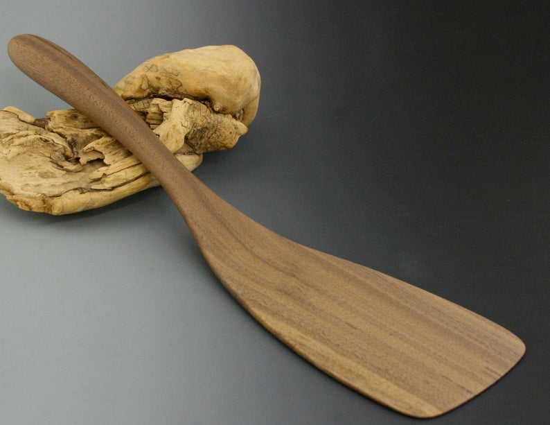 Handmade walnut wood flipper spatula with large blade and thin beveled edge..