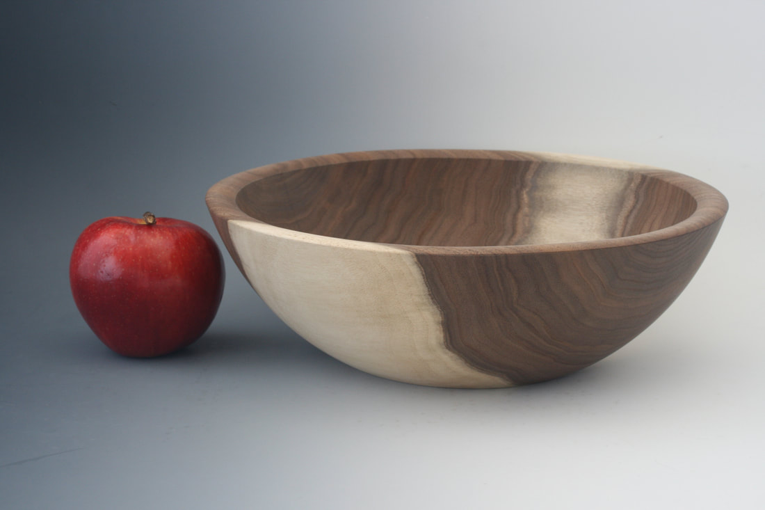 Black walnut wood bowl, wood turned, with apple for scale.