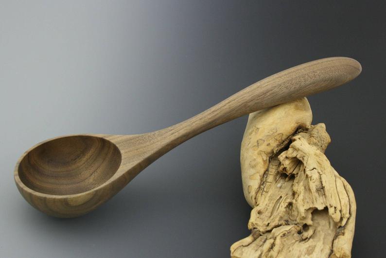 Small walnut wood table serving ladle.