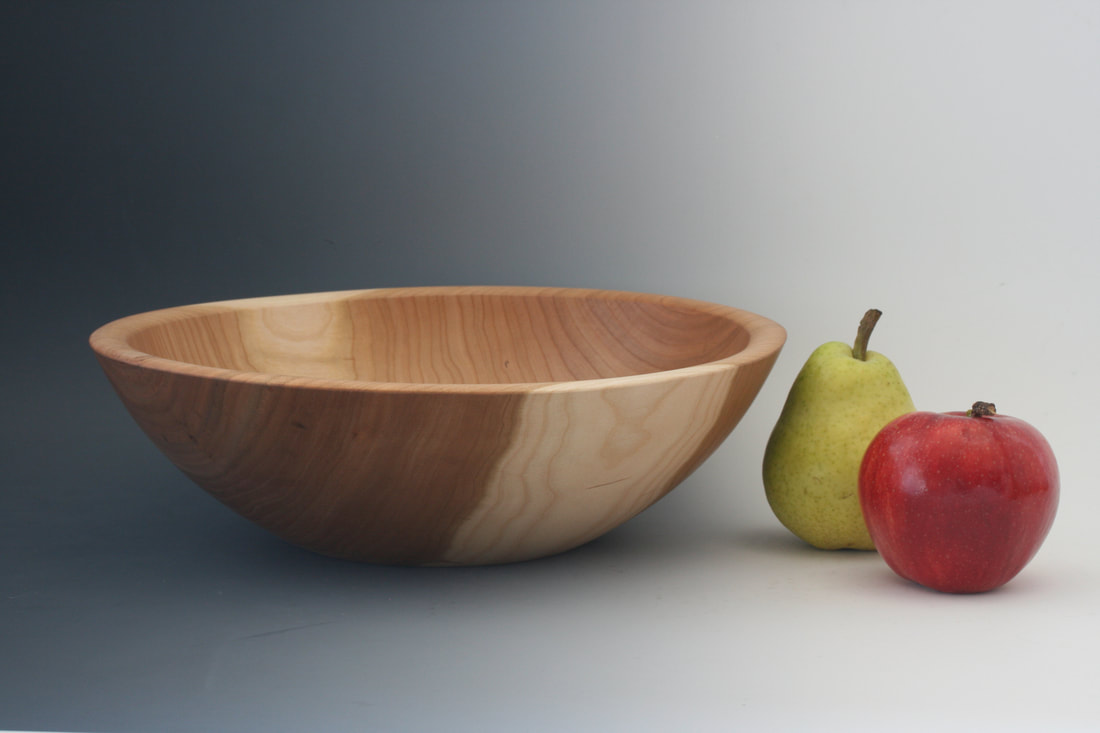 Cherry wood bowl, handturned, with fruit for scale.